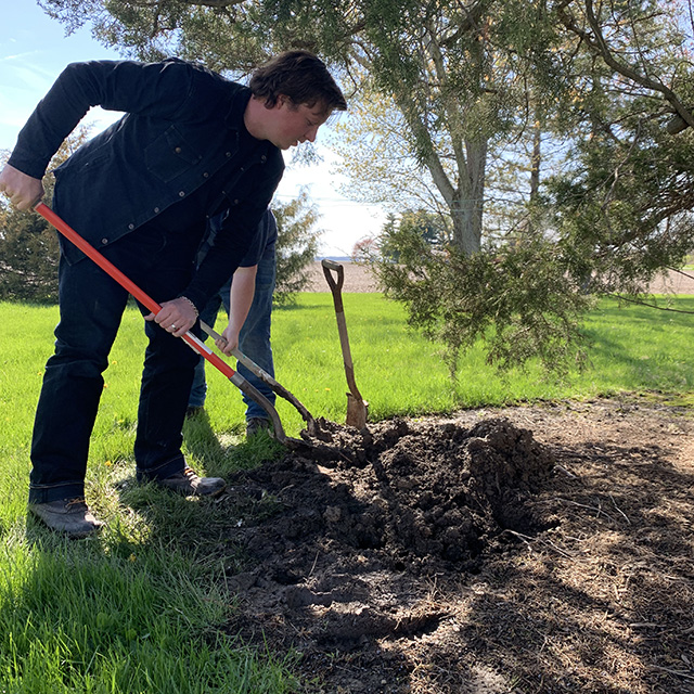 Luke Kuhn digging hole for pet dog Sophie_Born in Defiance