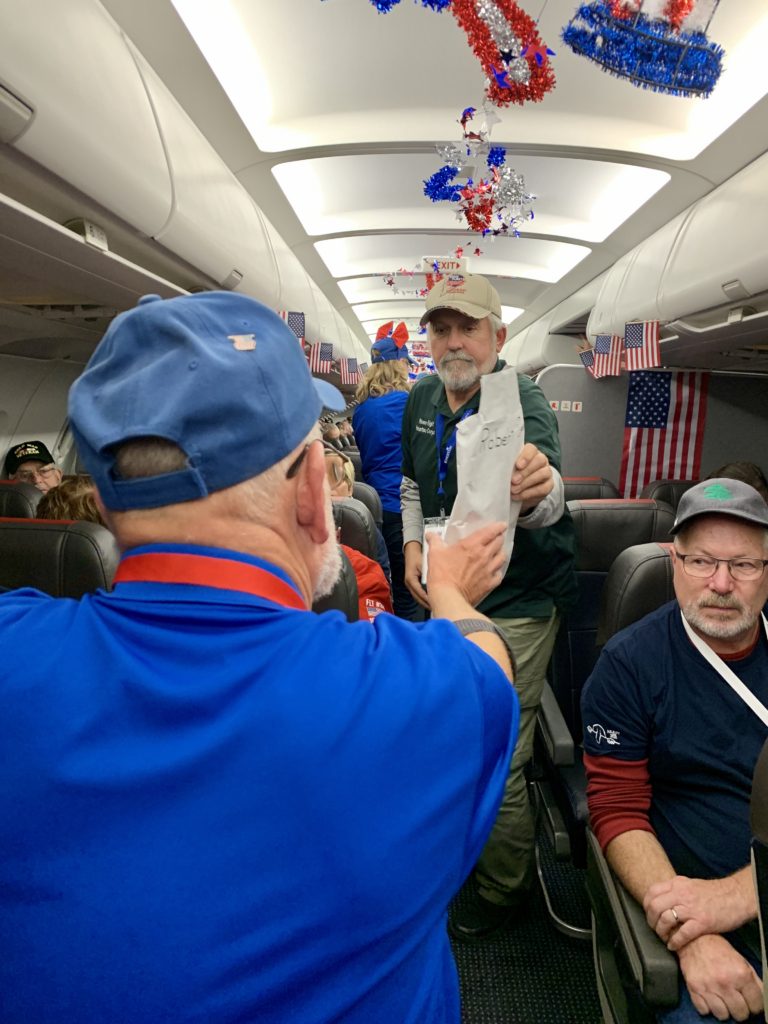 Mail call on Honor Flight airplane to say thank you to veterans for their service